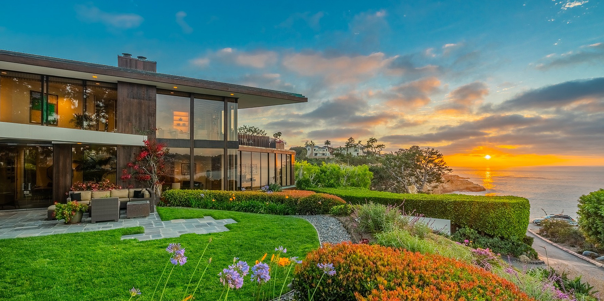 Coastal California home at sunset with ocean views and terraced garden