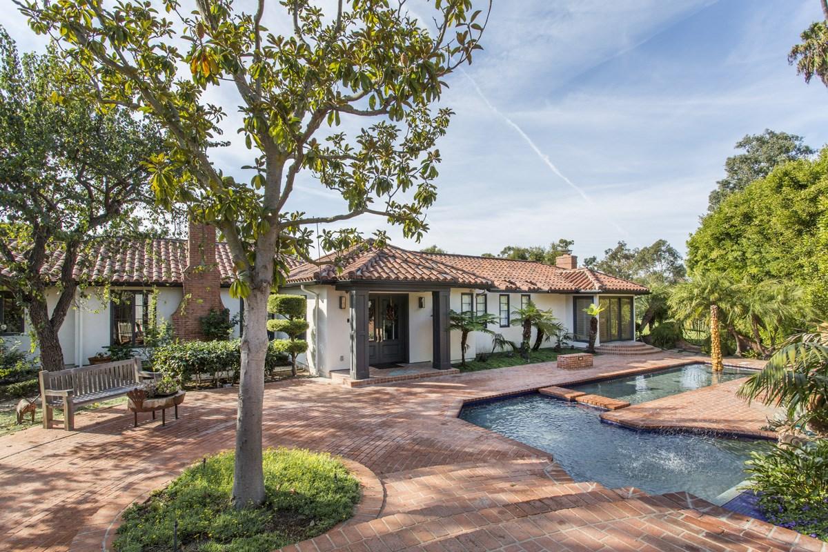 Finished Spanish colonial home with pool and mature landscaping