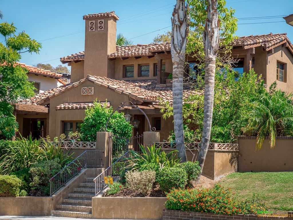 Spanish colonial residence with a tower element and mature landscaping