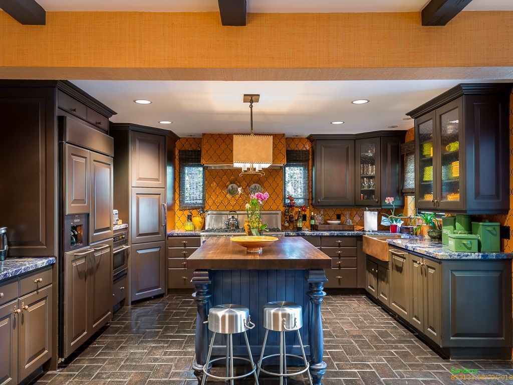 Renovated kitchen with a large island, custom cabinetry and stone counters